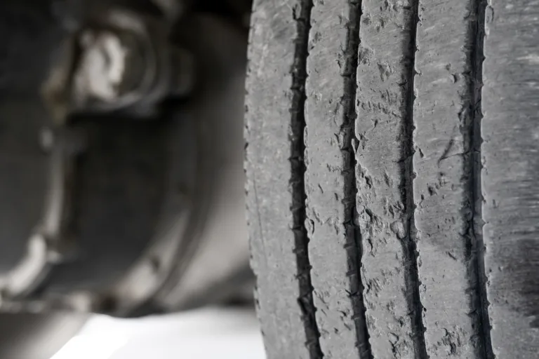 Exhausted truck tread old damaged and worn black tire tread